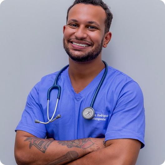 Smiling male doctor in blue scrubs with a stethoscope